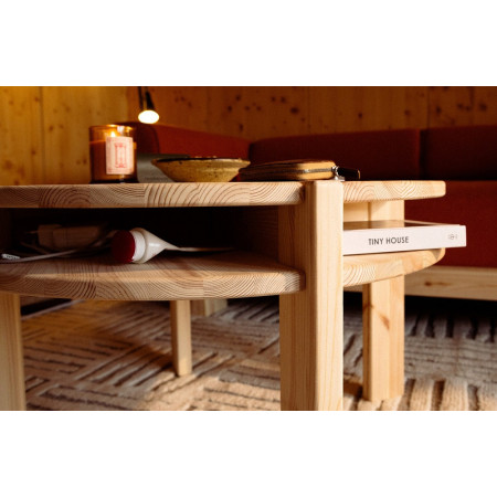 Close up view of round Tuck table with jigh shelf